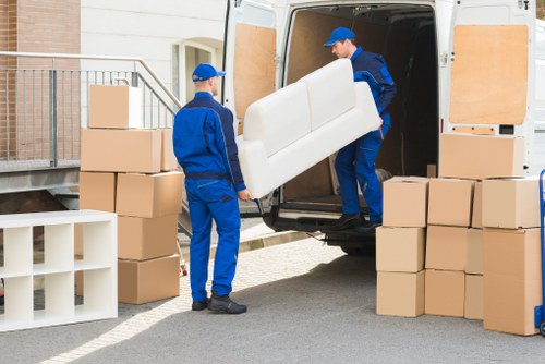 House moving team placing furniture and boxes in the new Coombe home