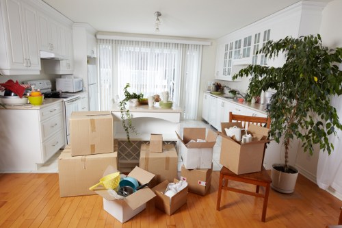 Staff wearing PPE while moving furniture and boxes safely