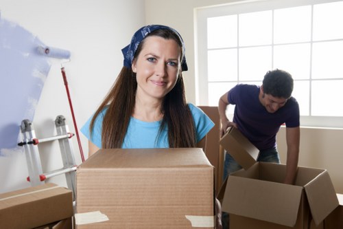 House removal team handling furniture in a Coombe property