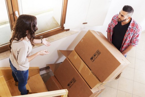Mover carrying furniture for a Coombe home or business relocation