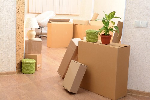 Packing fragile household items for a move in Coombe
