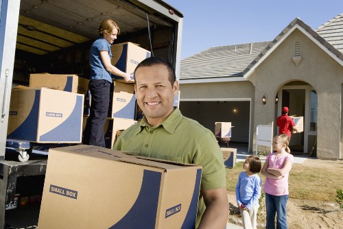 Movers unloading belongings at a Coombe property